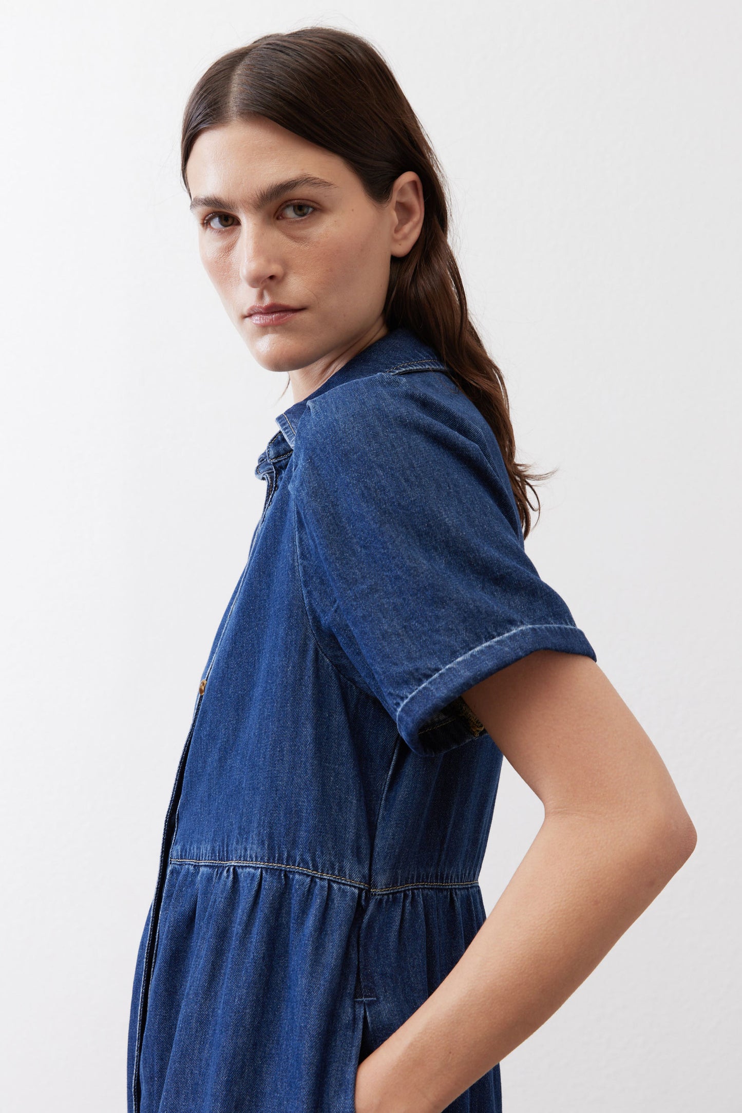 Medium-wash denim midi dress with short sleeves and tiered waist seam