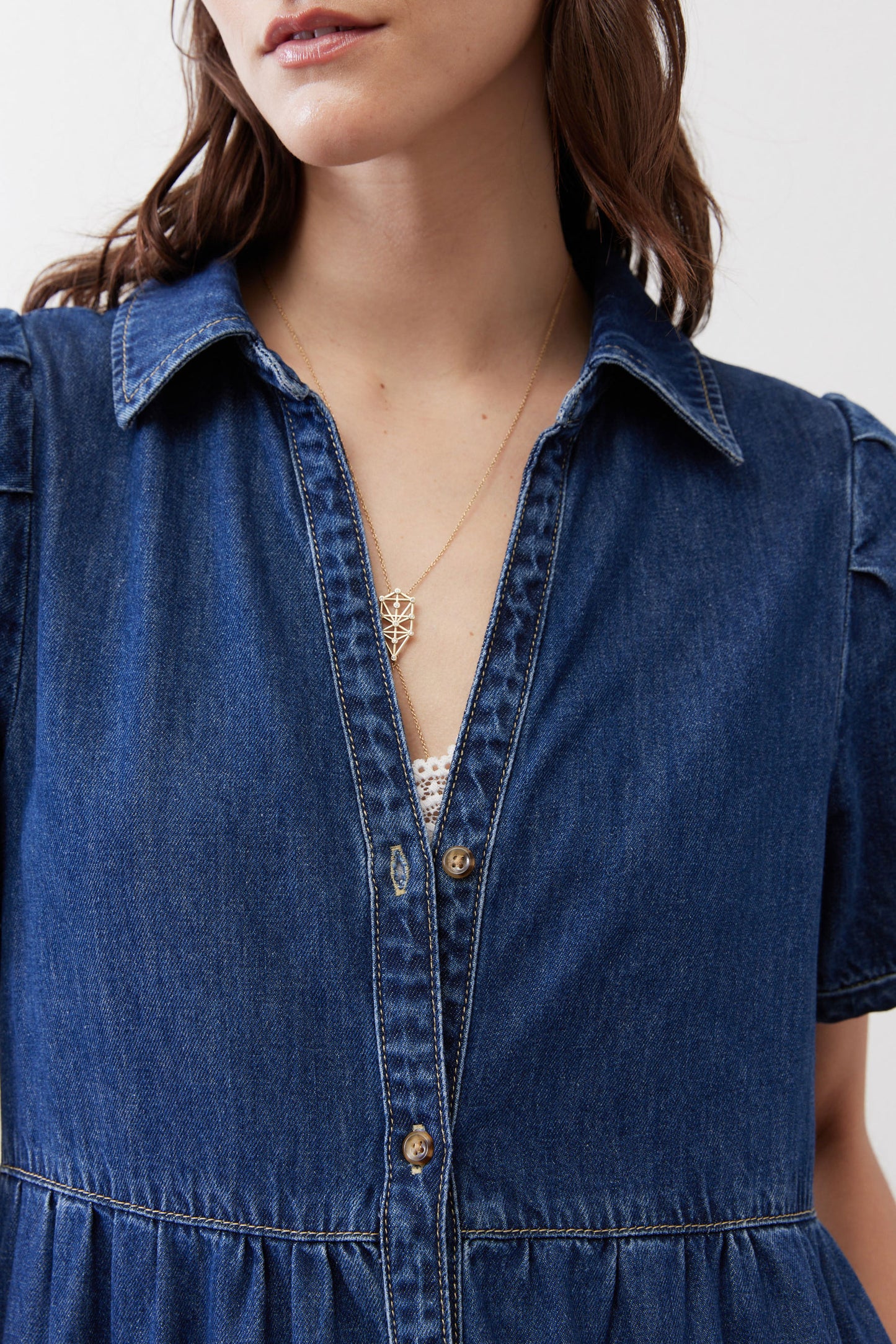 Denim midi dress close-up: collared button front with V neckline
