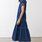 Medium-wash denim midi dress with short sleeves, tiered skirt, and button front