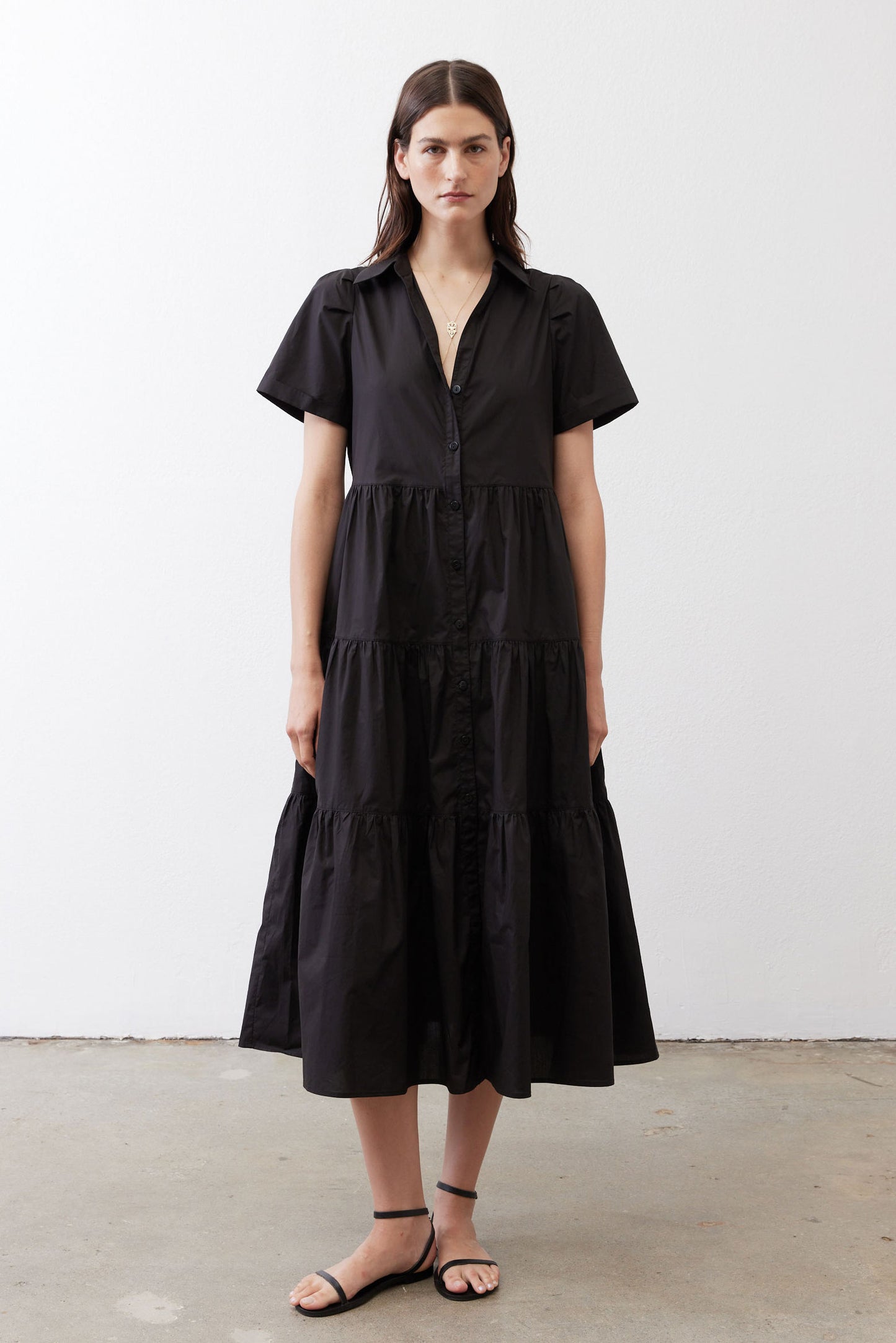 Black long poplin dress with short sleeves, V-neck, and tiered silhouette