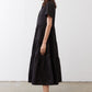 Black long dress from side view with tiered skirt and short sleeves