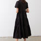 Black long dress from back view with tiered skirt and short sleeves