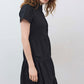 Black long poplin dress with V-neck, tiered skirt, and short cuffed sleeves