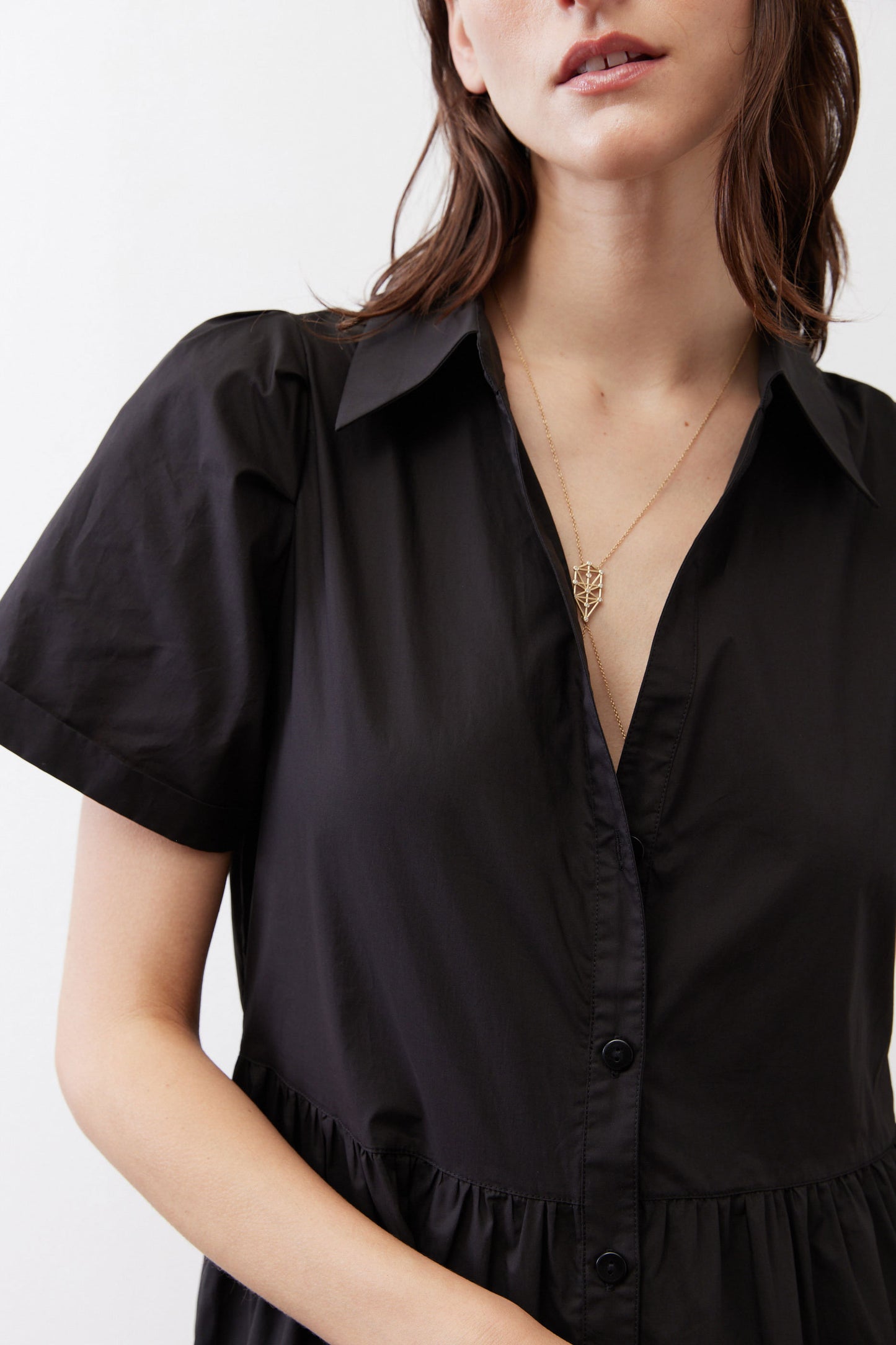 Black button-front dress bodice with V-neck and short sleeves, gathered waist