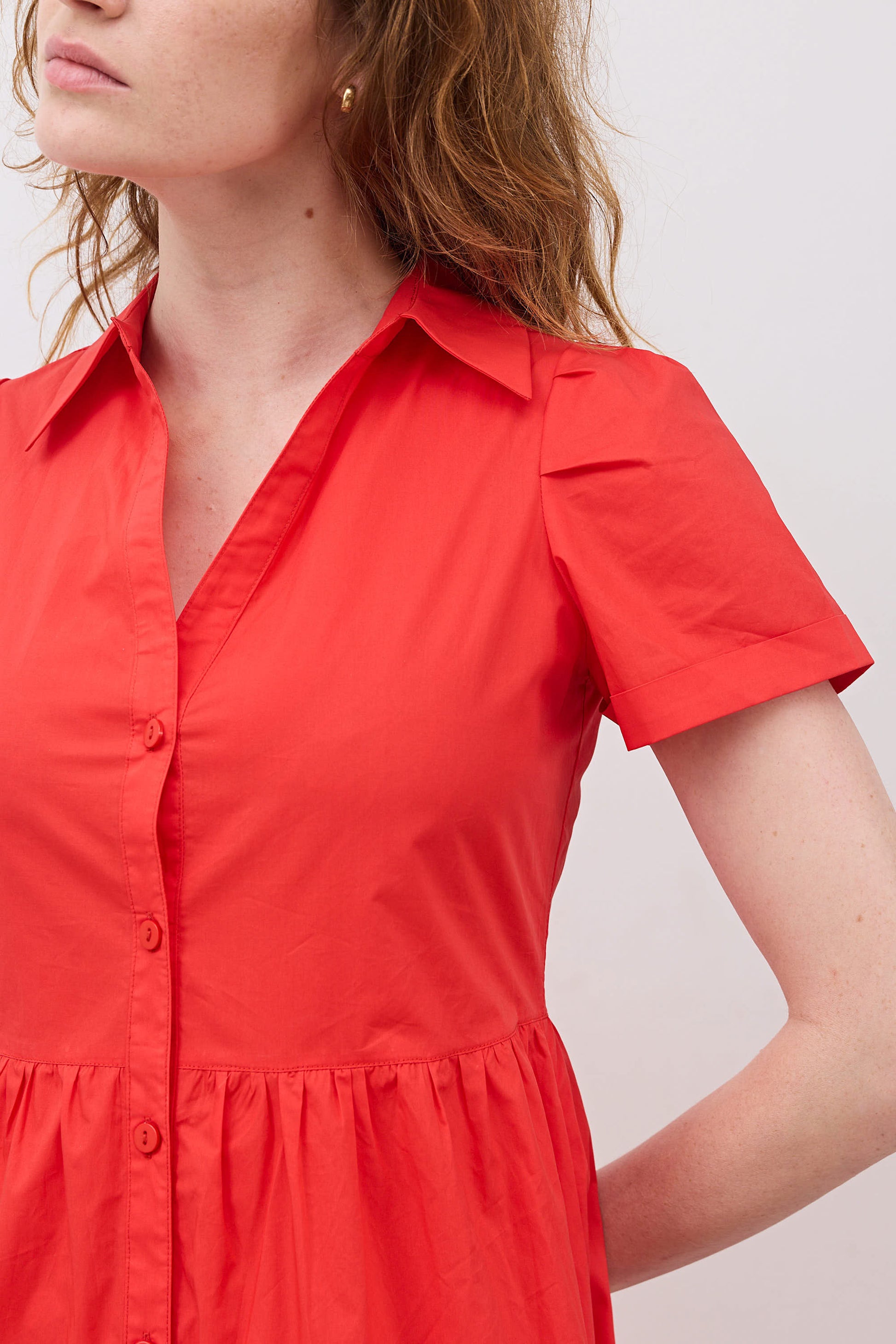 Hot coral poplin dress close-up: V-neck button placket and short sleeves