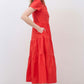 Hot coral long poplin dress from side view with tiered skirt and short sleeves