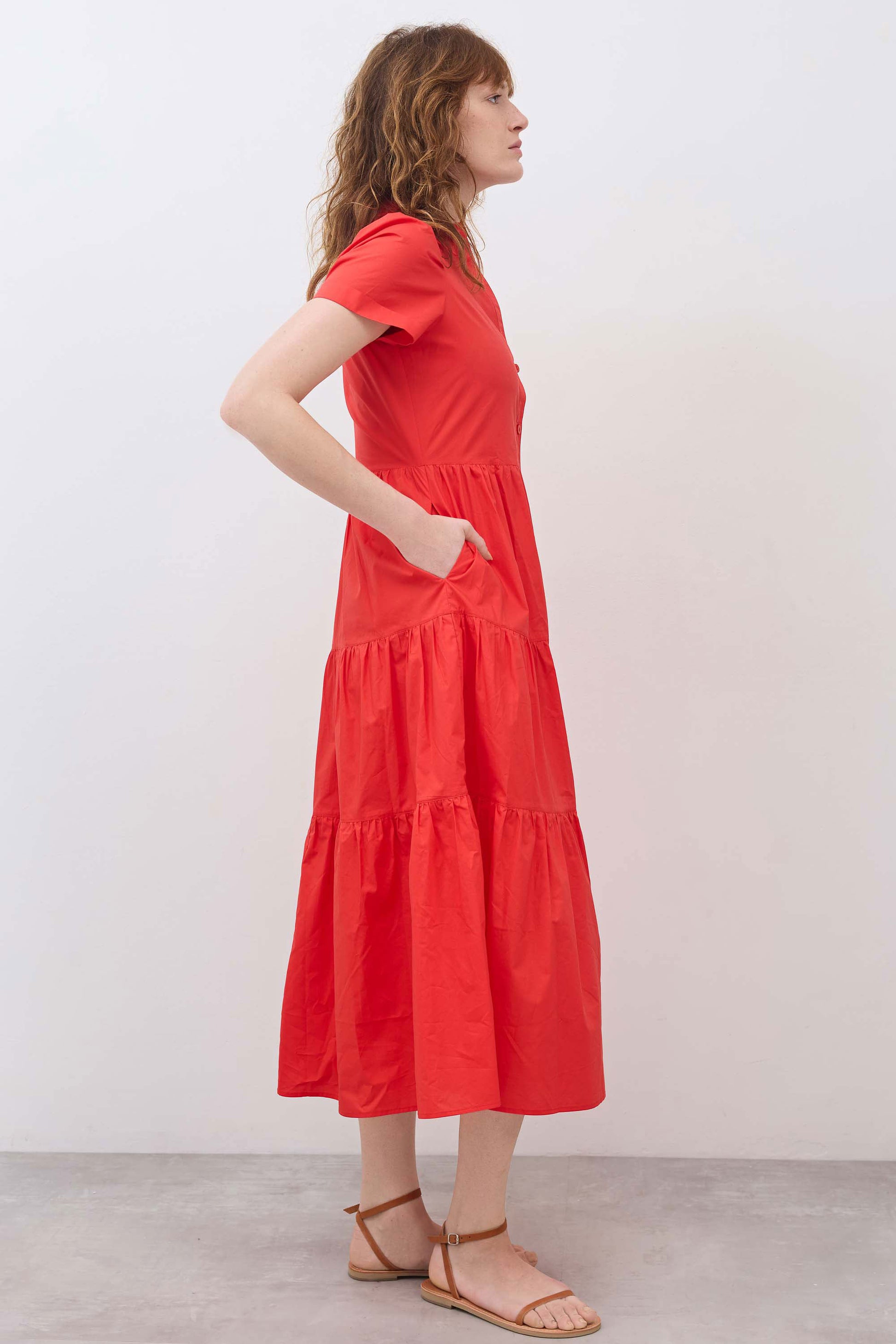 Hot coral long poplin dress from side view with tiered skirt and short sleeves