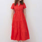 Hot coral long poplin dress standing front view with button front and tiered skirt