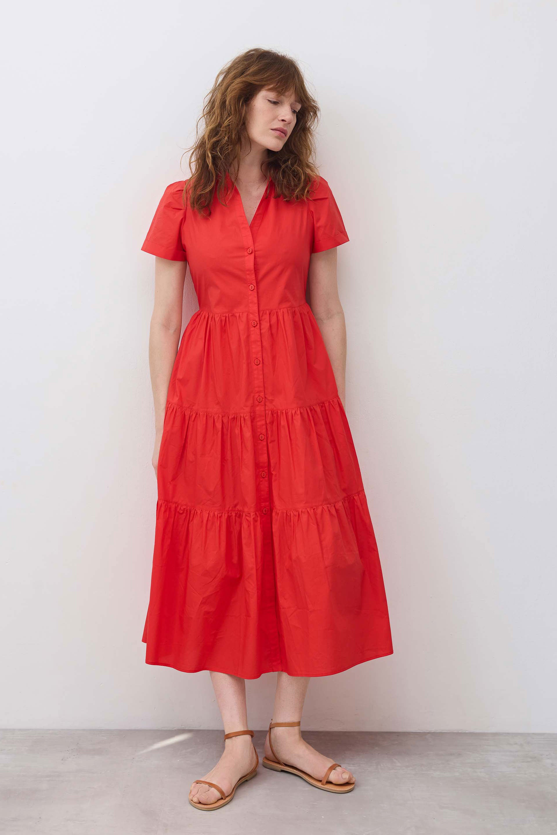 Hot coral long poplin dress standing front view with button front and tiered skirt