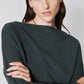 Brushed rib dolman top close-up, dark green ribbed knit texture