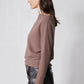 Medium taupe brushed rib dolman top in side profile with mock neck and long sleeves