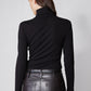 Back view of black brushed ribbed turtleneck, high collar and long sleeves