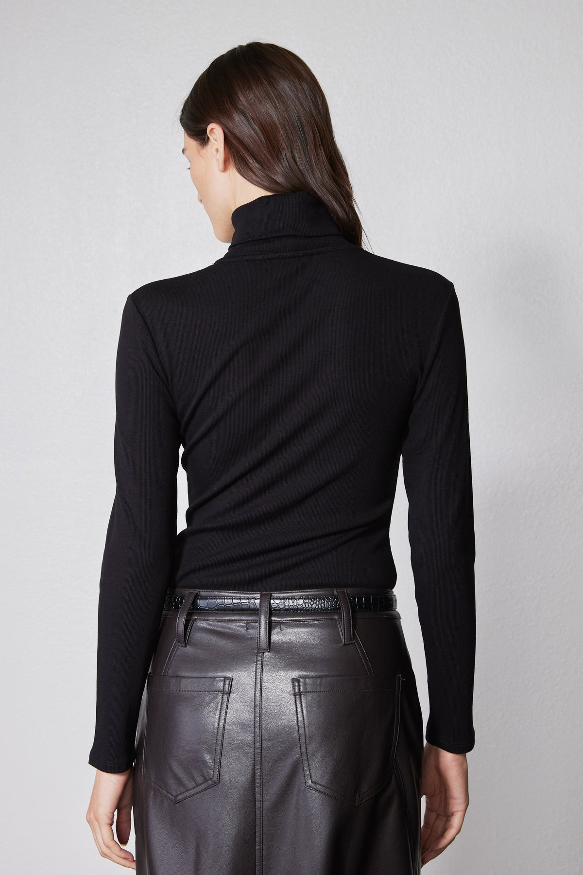 Back view of black brushed ribbed turtleneck, high collar and long sleeves