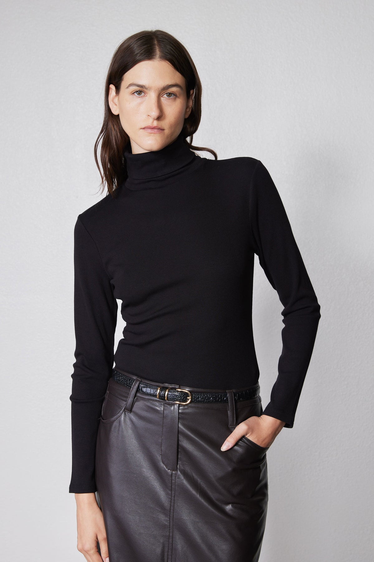 Black fitted turtleneck sweater with brushed ribbed texture and high neck