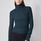 Forest green ribbed turtleneck top, long sleeves with fitted waist and high neck