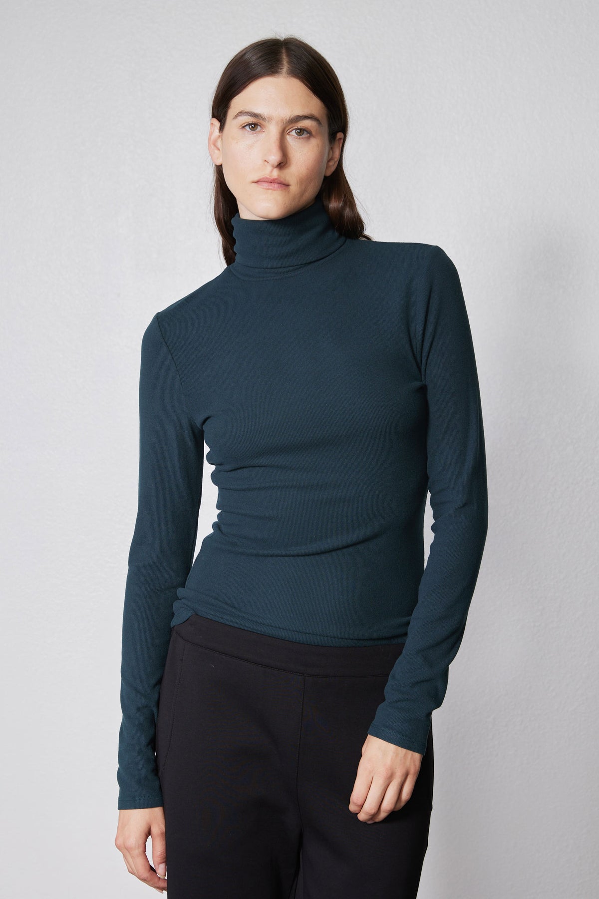 Forest green ribbed turtleneck top, long sleeves with fitted waist and high neck