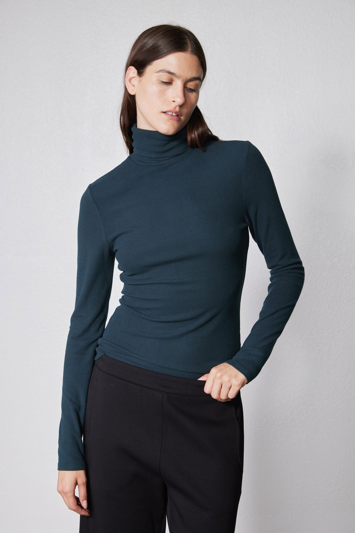 Forest green ribbed turtleneck long-sleeve top with high collar and snug fit