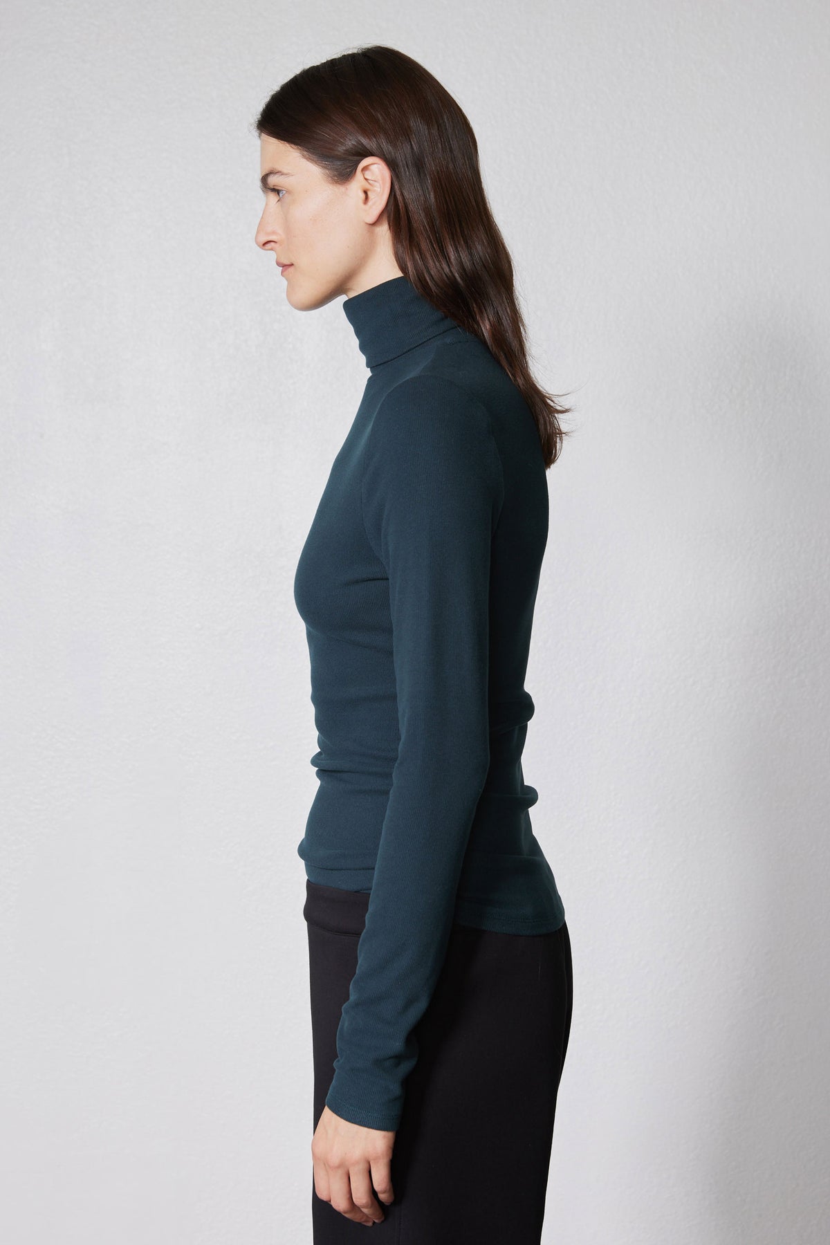 Forest green ribbed turtleneck long-sleeve top, side view with high collar