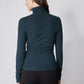 Forest green ribbed turtleneck top, long sleeves and high collar from behind