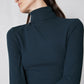 Forest green ribbed turtleneck, high collar detail and long sleeves close-up