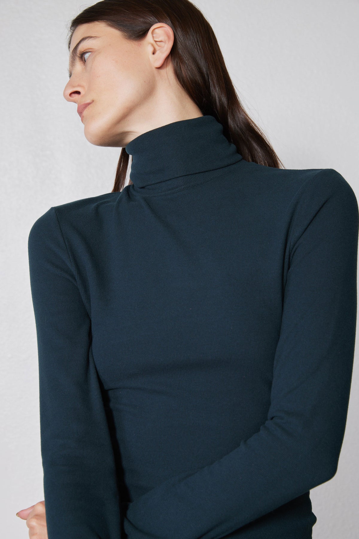 Forest green ribbed turtleneck, high collar detail and long sleeves close-up