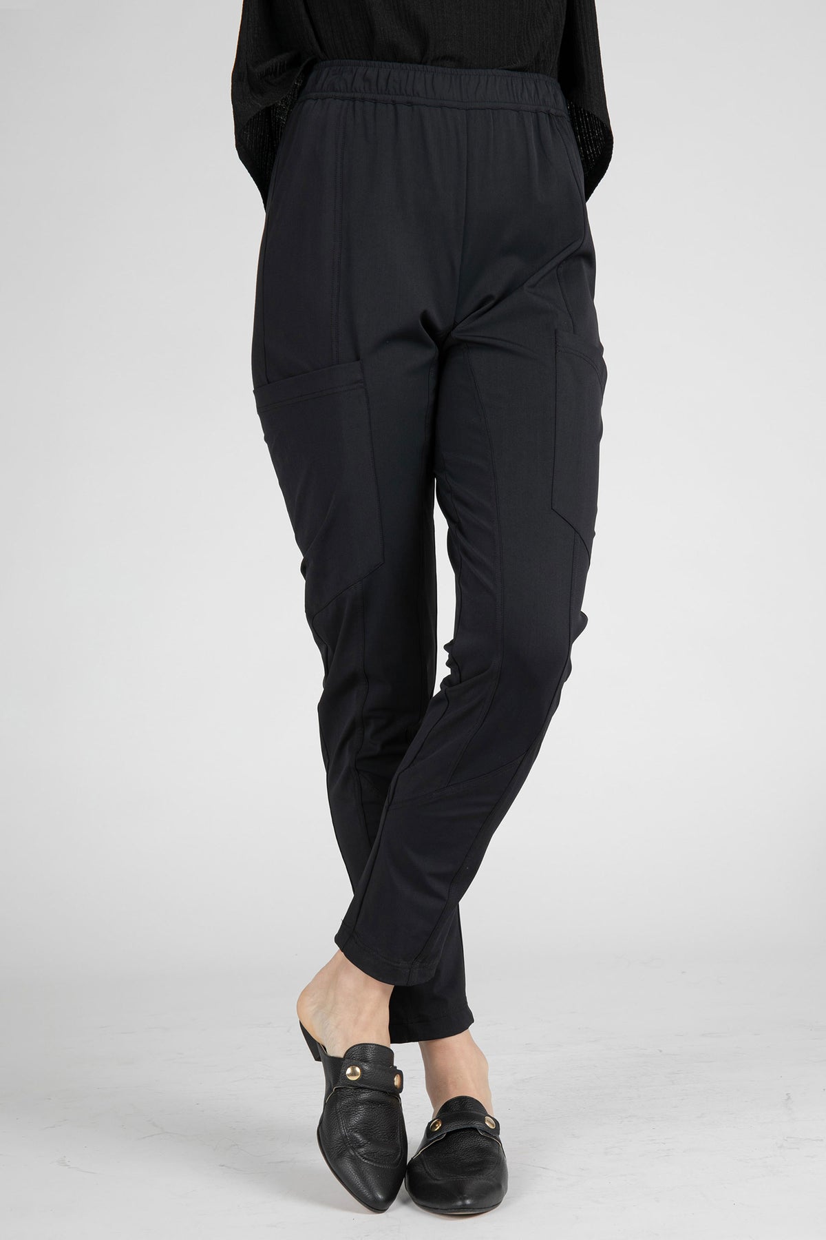Black cargo pants back view with cuffed ankles and relaxed tapered legs.
