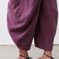 Deep purple wide-leg pants with pleated drape and ankle-length hem