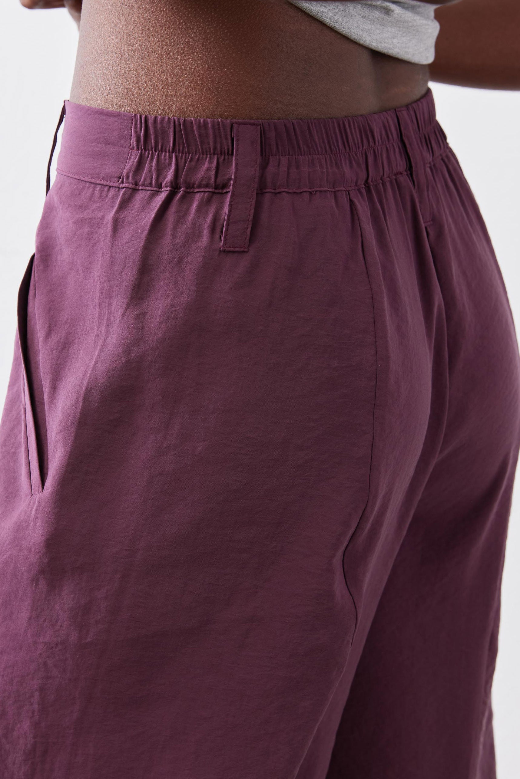 Deep purple elastic waistband pants with front slash pockets