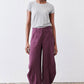 Deep purple wide-leg pants with gathered elastic waist and button closure