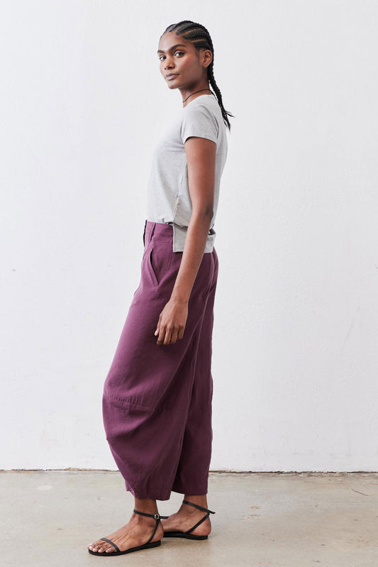 Deep purple wide-leg pants with roomy legs and ankle-length hem