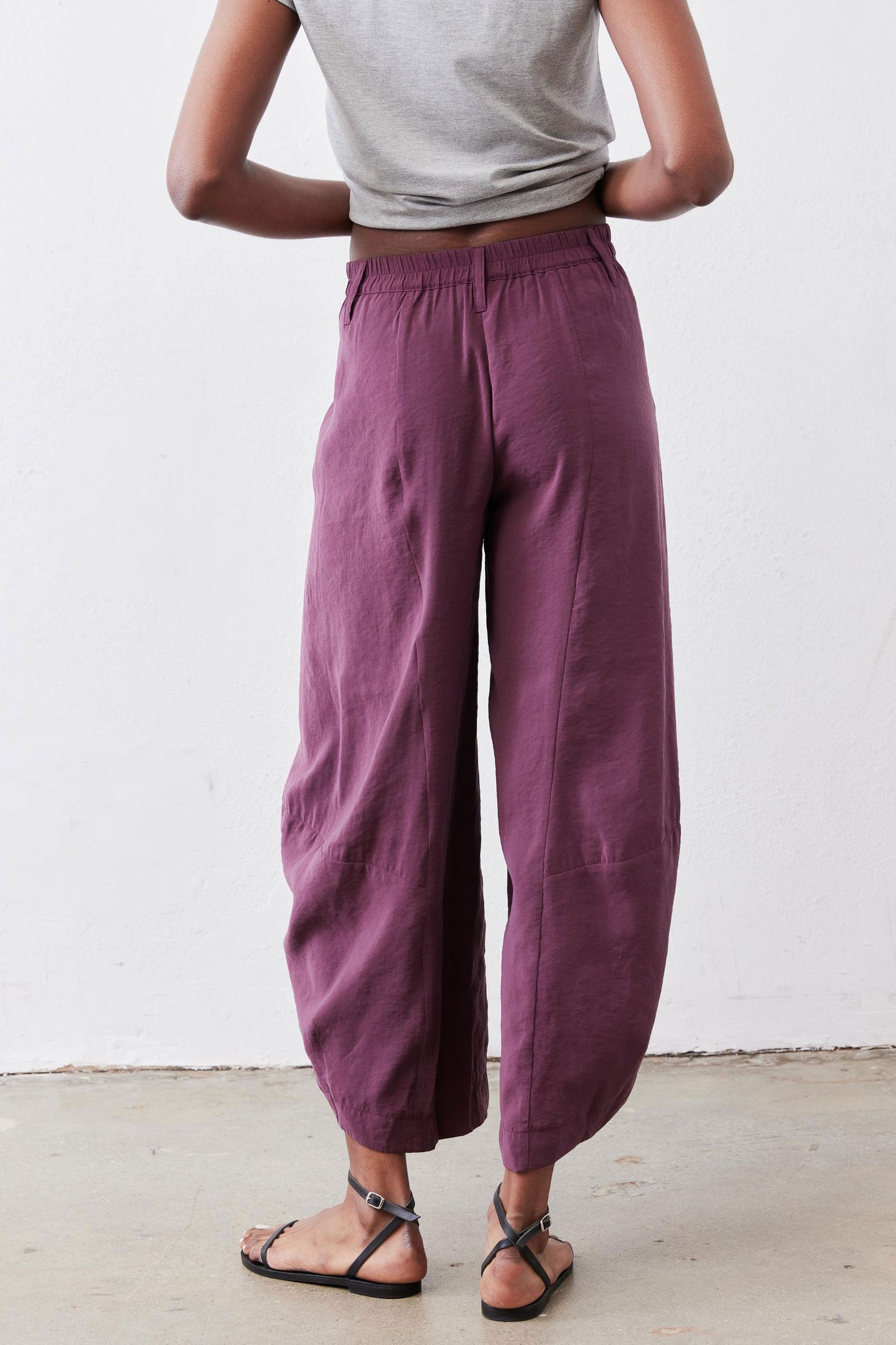 Deep purple wide-leg pants with elastic waist and back seam detail