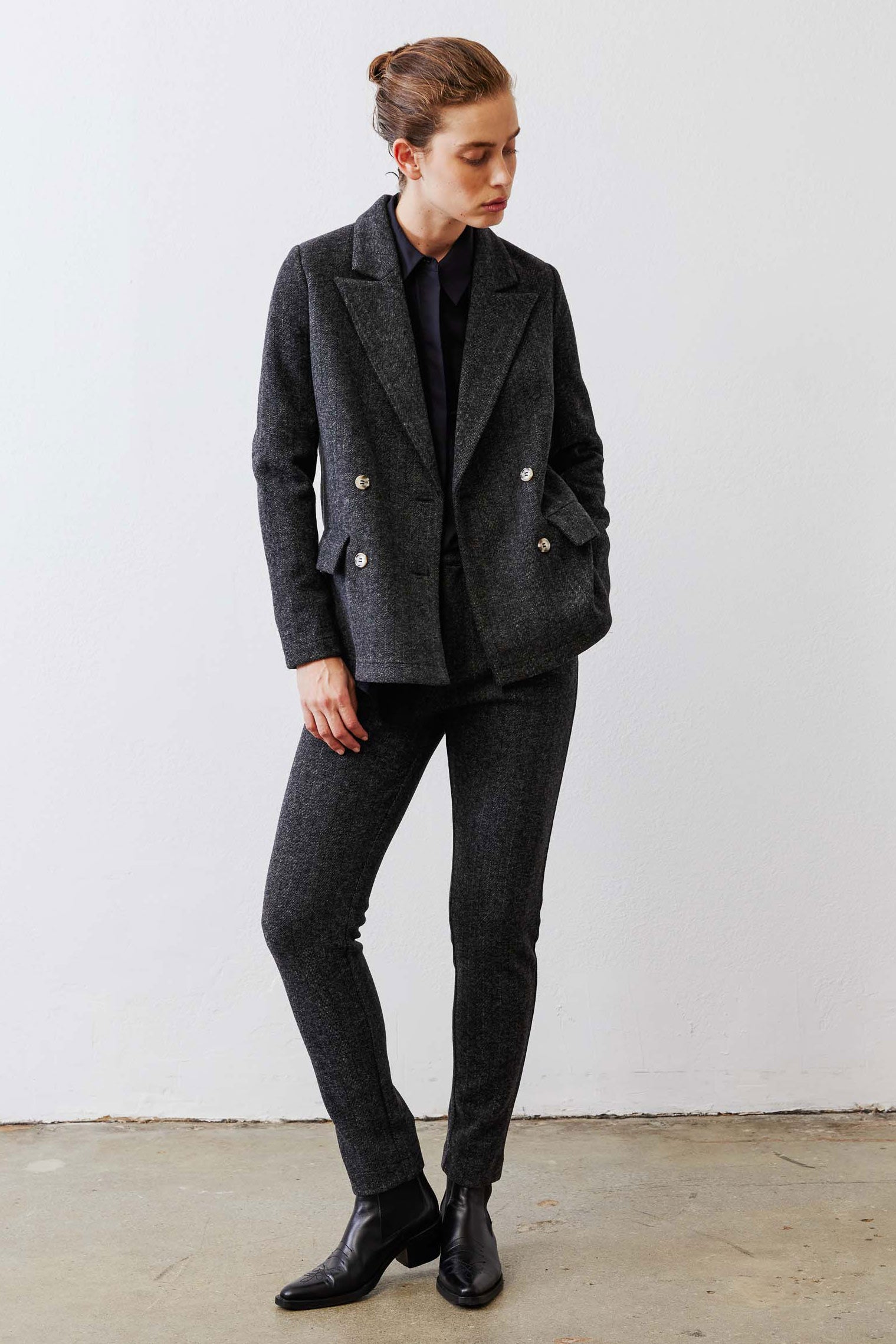 Charcoal herringbone double-breasted blazer with gold buttons and long sleeves