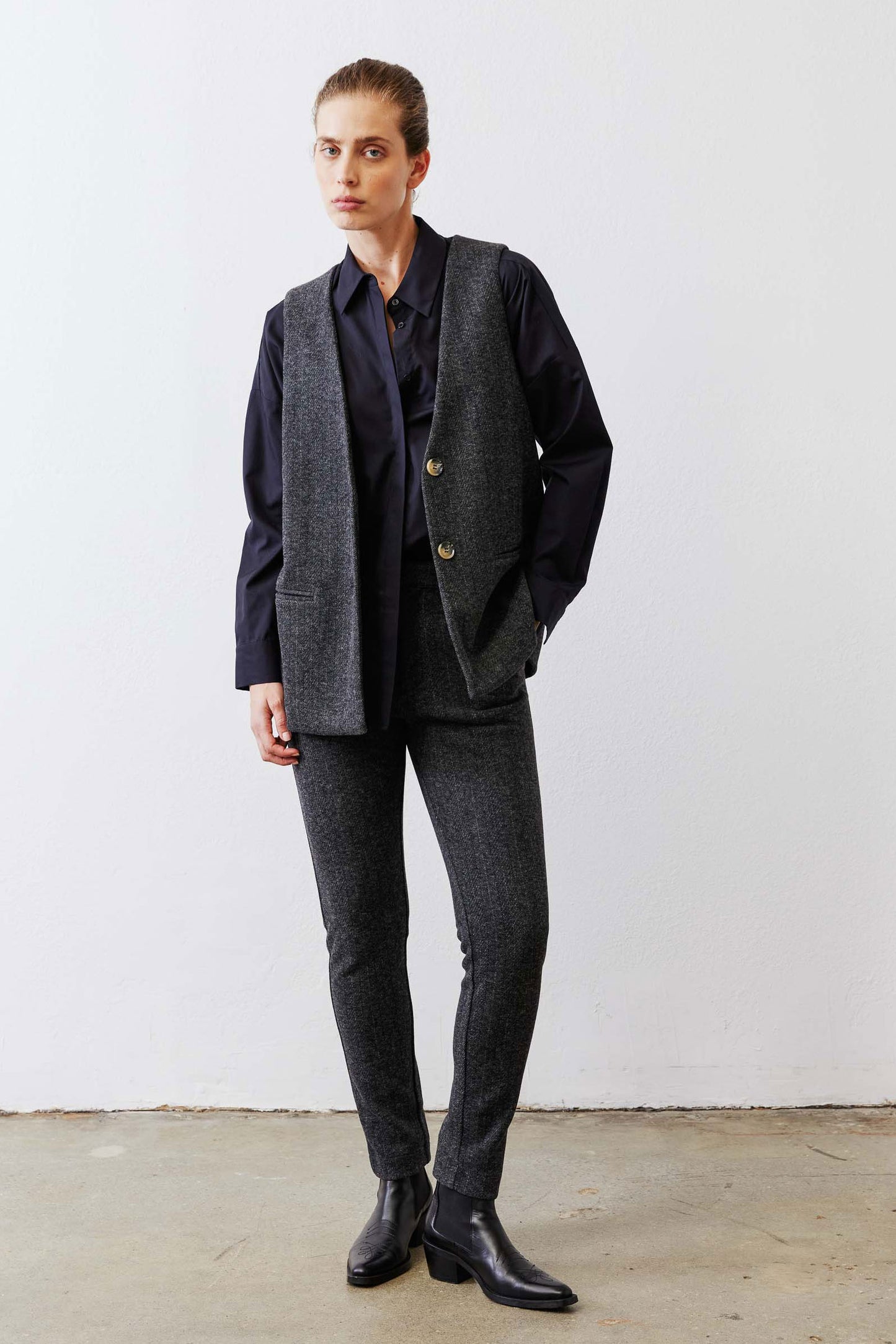 Charcoal longline herringbone vest with notch lapels and two gold buttons