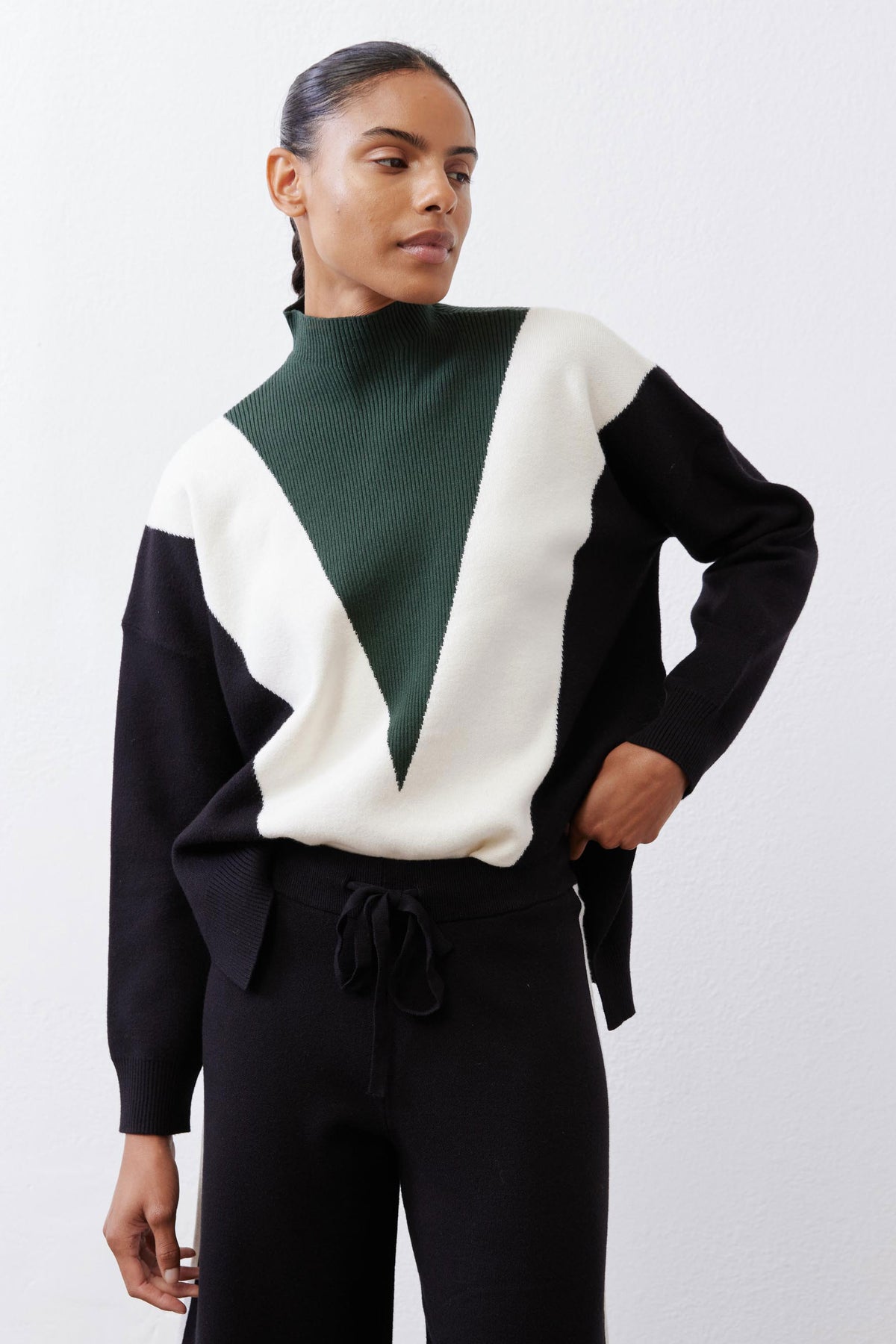 Chevron colorblock turtleneck sweater, forest green with cream and black long sleeves.