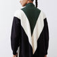 Chevron colorblock knit sweater with turtleneck, forest green, cream, and black panels.