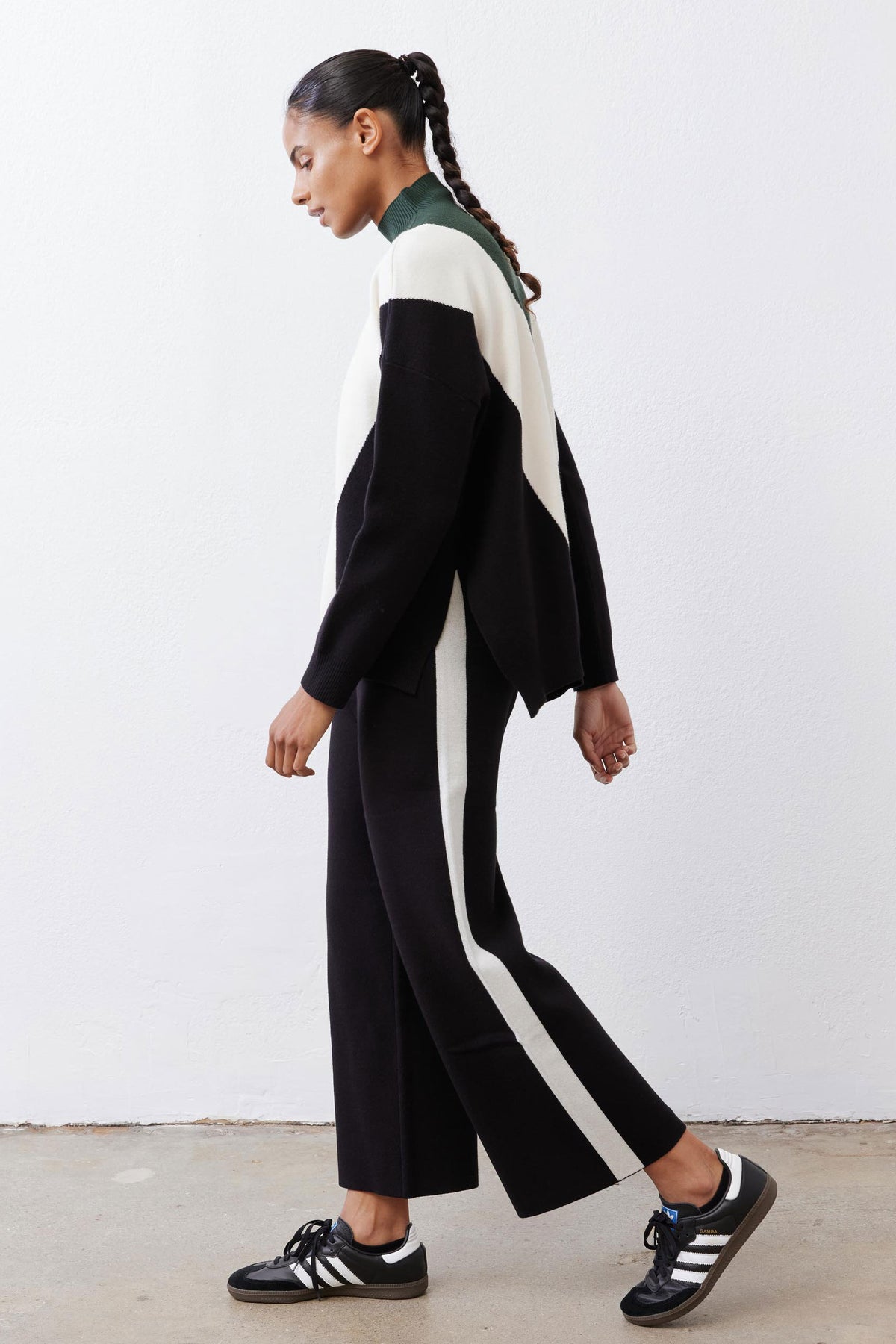 Chevron colorblock knit sweater, forest green center with cream V and black side panels.