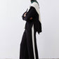 Black lounge pants with ivory side stripe and drawstring waist, wide-leg fit
