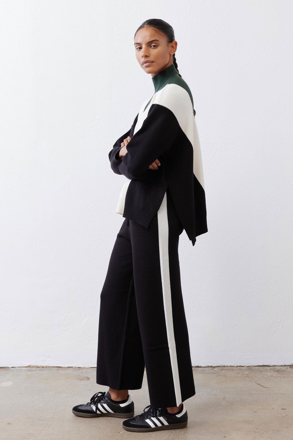 Black lounge pants with ivory side stripe and drawstring waist, wide-leg fit