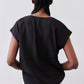 Black poplin top back view with draped center and short sleeves