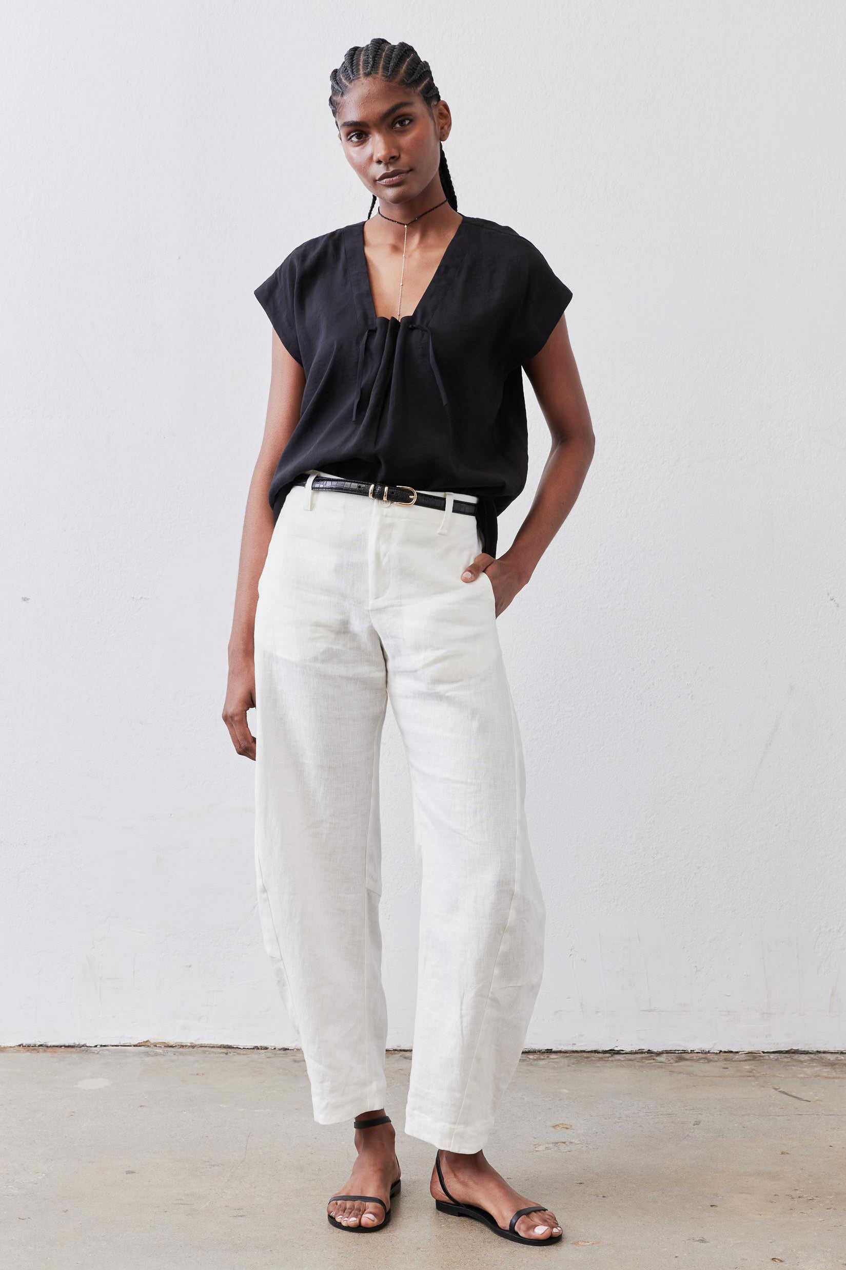 Black poplin top with cinched V neckline and short sleeves, front view
