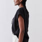 Black poplin top with cinched V back detail and short sleeves, side view