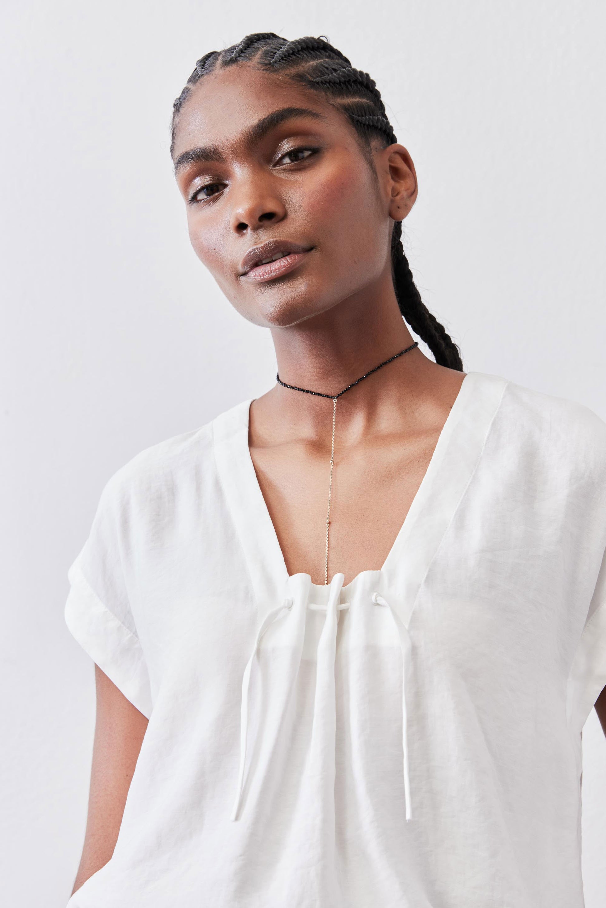 White cinched-neck poplin top with drawstring, short batwing sleeves