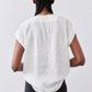 Back view: white poplin top with short sleeves and relaxed fit
