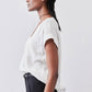 White cinched-neck poplin top, short sleeves, side profile