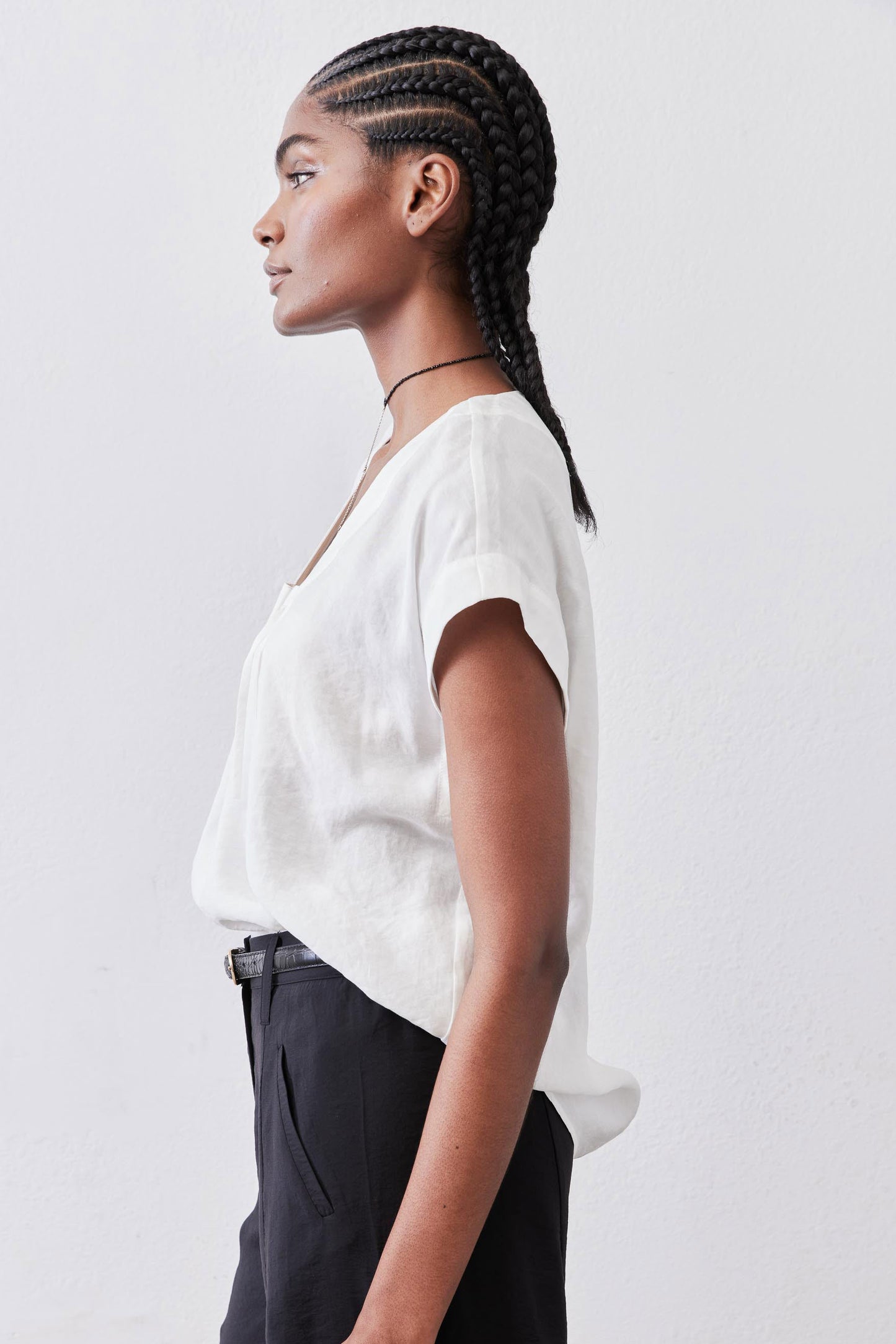 White cinched-neck poplin top, short sleeves, side profile