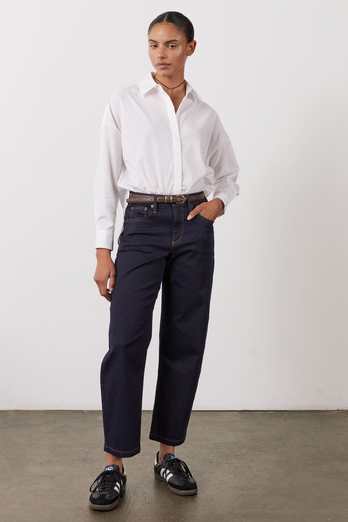 Dark wash barrel-leg jeans with cuffed hem, high rise fit, front pockets and belt loops.