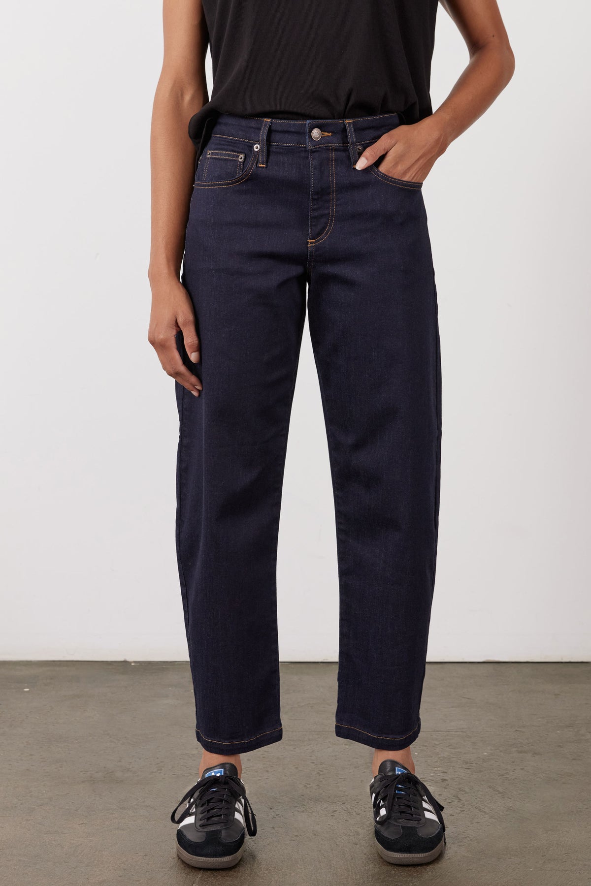Dark wash barrel-leg jeans, front view, button closure, belt loops, five-pocket style.