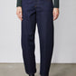 Dark wash denim barrel-leg jeans with belt loops, front pockets, and stitched seams