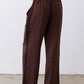 Dark brown wide-leg trousers with gathered elastic waistband and black side stripe