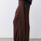 Dark brown wide-leg pants with black side stripe and long relaxed leg opening